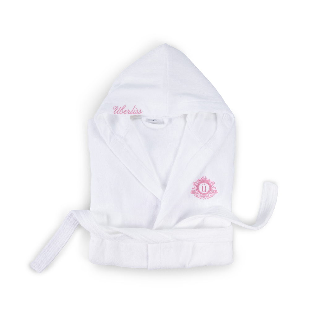 White hooded robe with pink branding on a white background